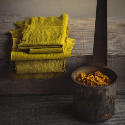 Turmeric powder and dye pot setup for dyeing fabric with turmeric at home