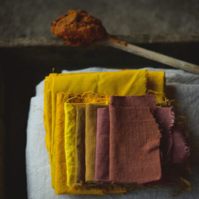 Linen and cotton fabric samples dyed with turmeric: yellow and brown shades