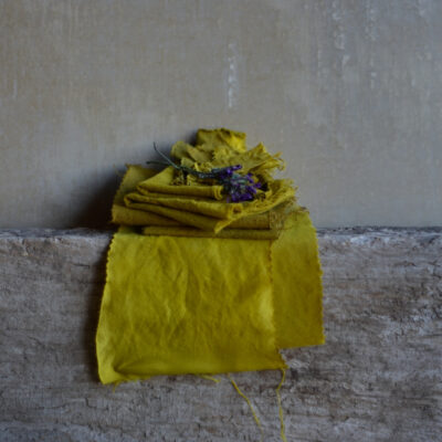 Stack of linen and wool fabrics dyed with turmeric