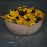 Bowl filled with rudbeckia to dye yellow or pink naturally